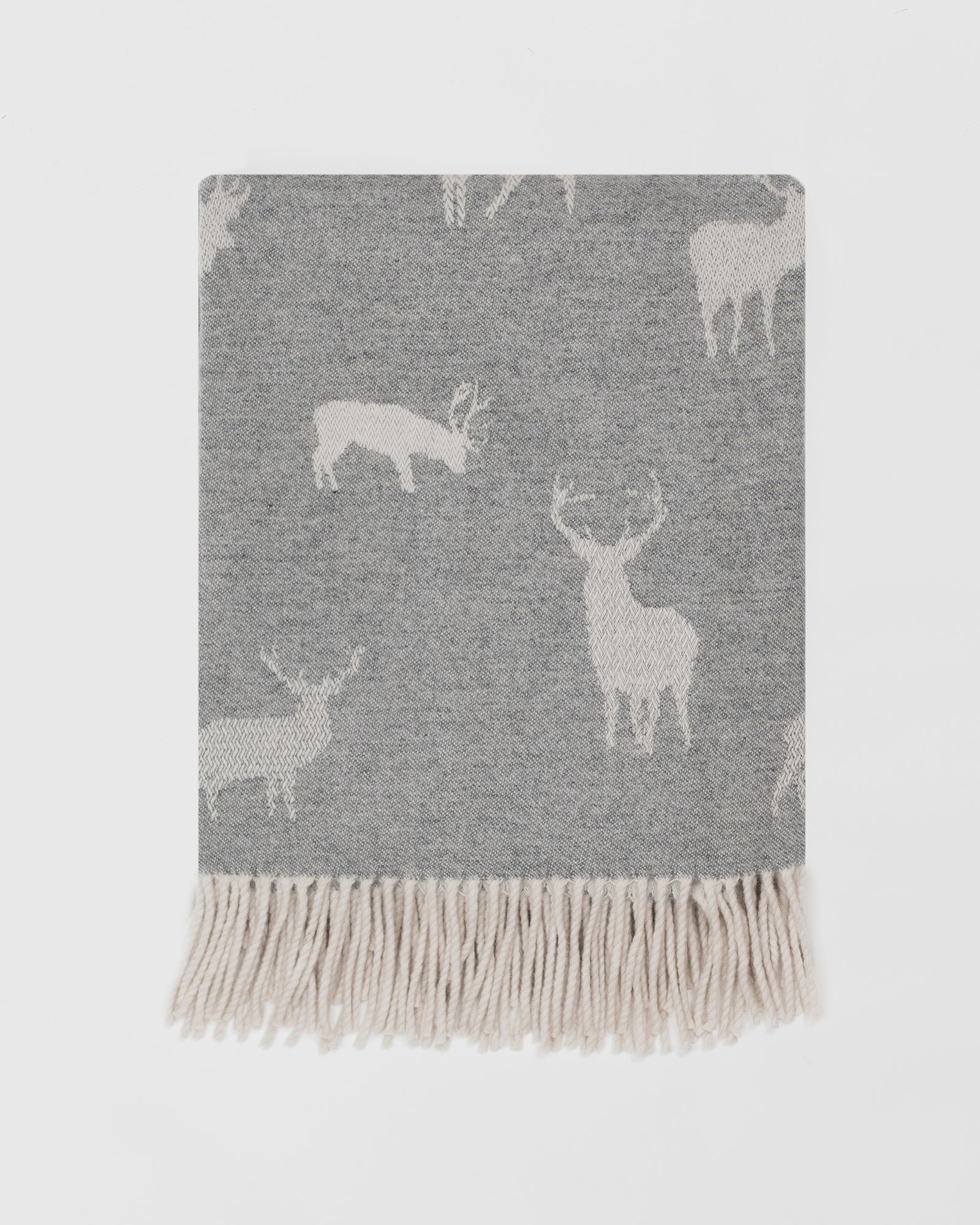 Remony nature stag grey blanket with deer pattern and white fringe on a light grey background