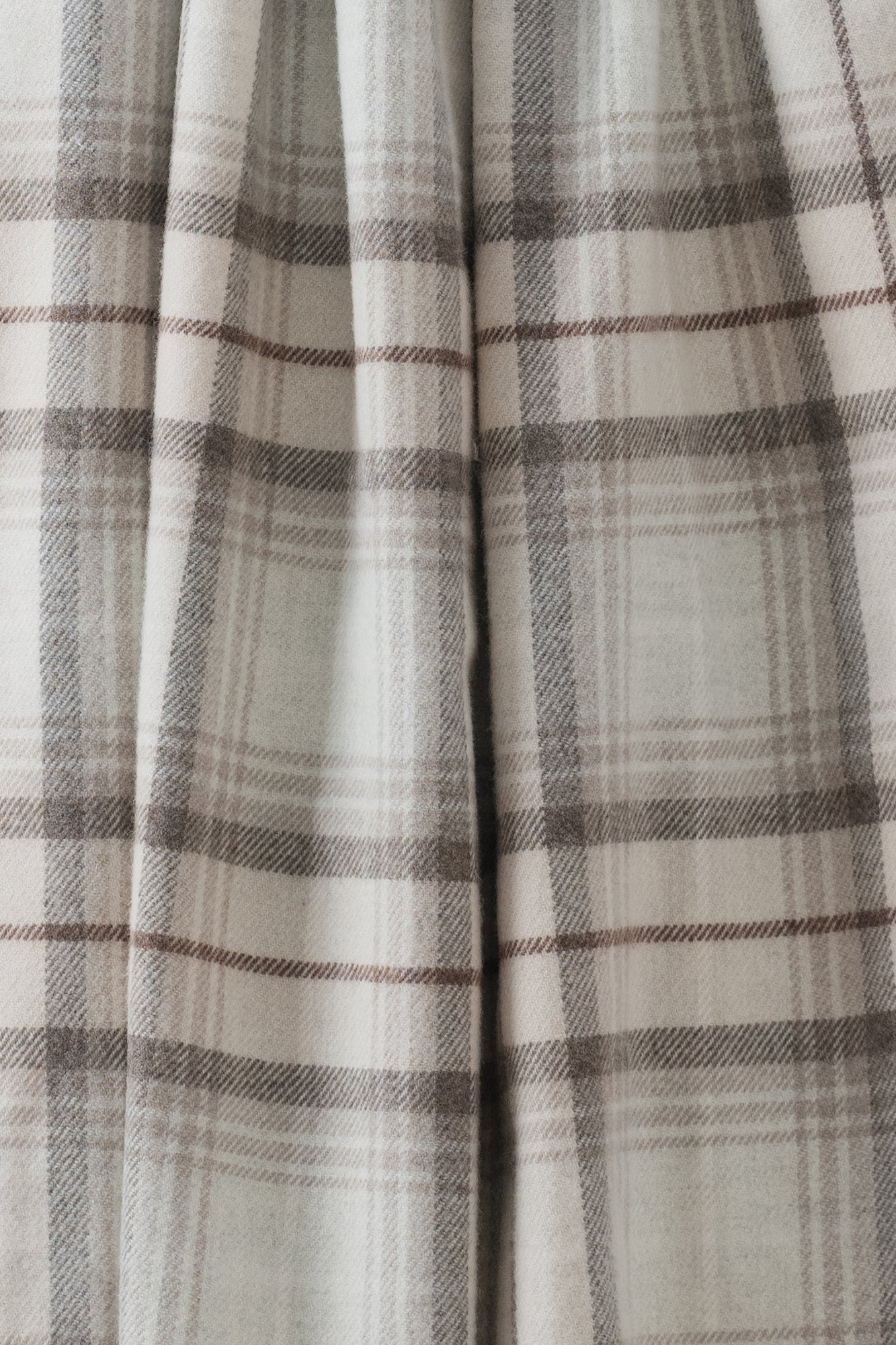 Remony Lindores Mushroom stole, Close-up of plaid fabric with a neutral color palette