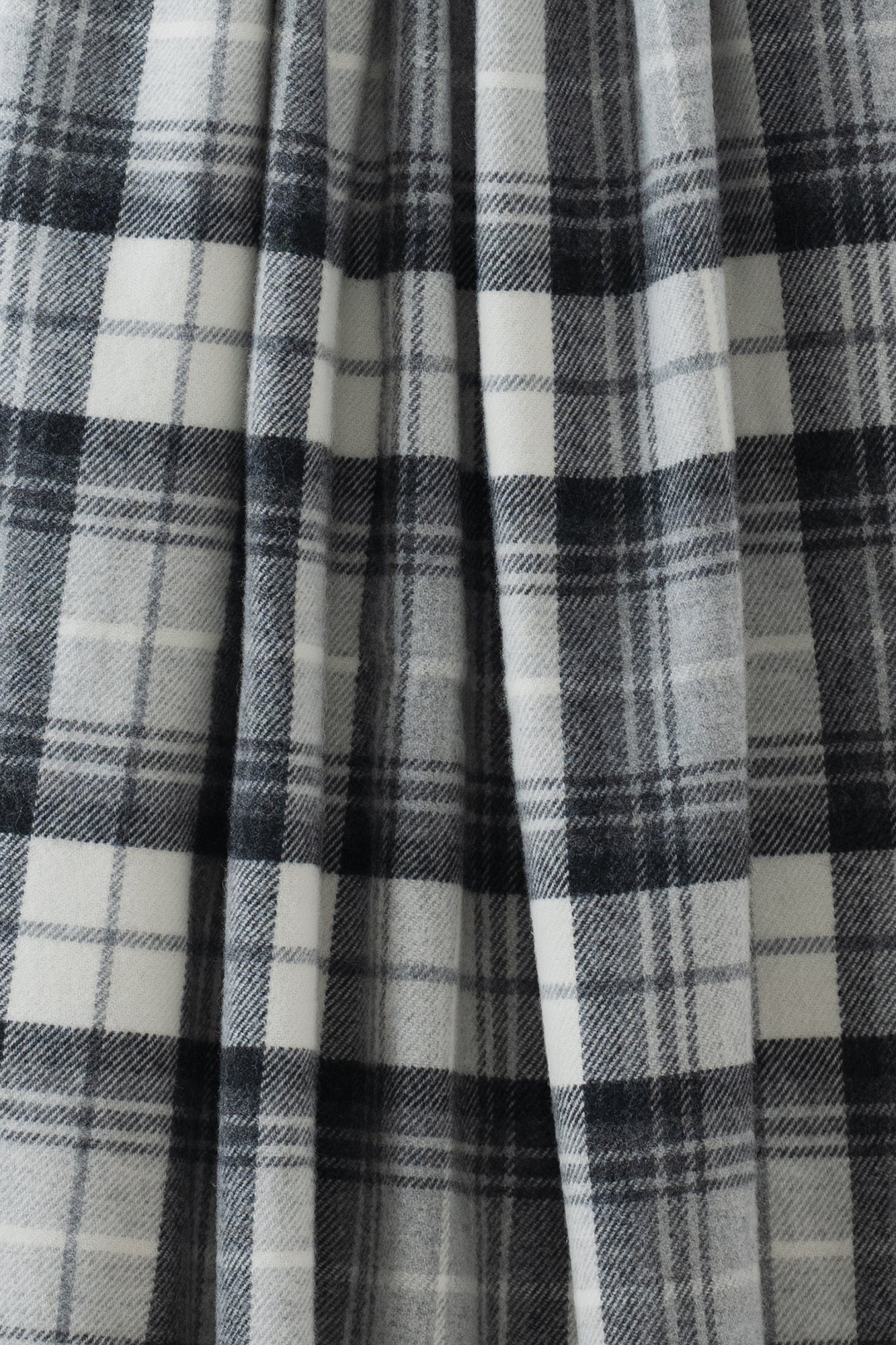 Remony lindores slate stole - Close-up of a plaid fabric with black, white, and gray colors.