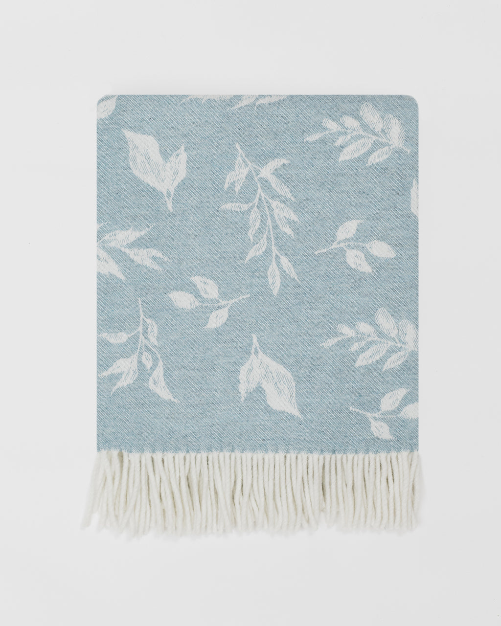 Remony Nature leaf throw topaz folded on grey background