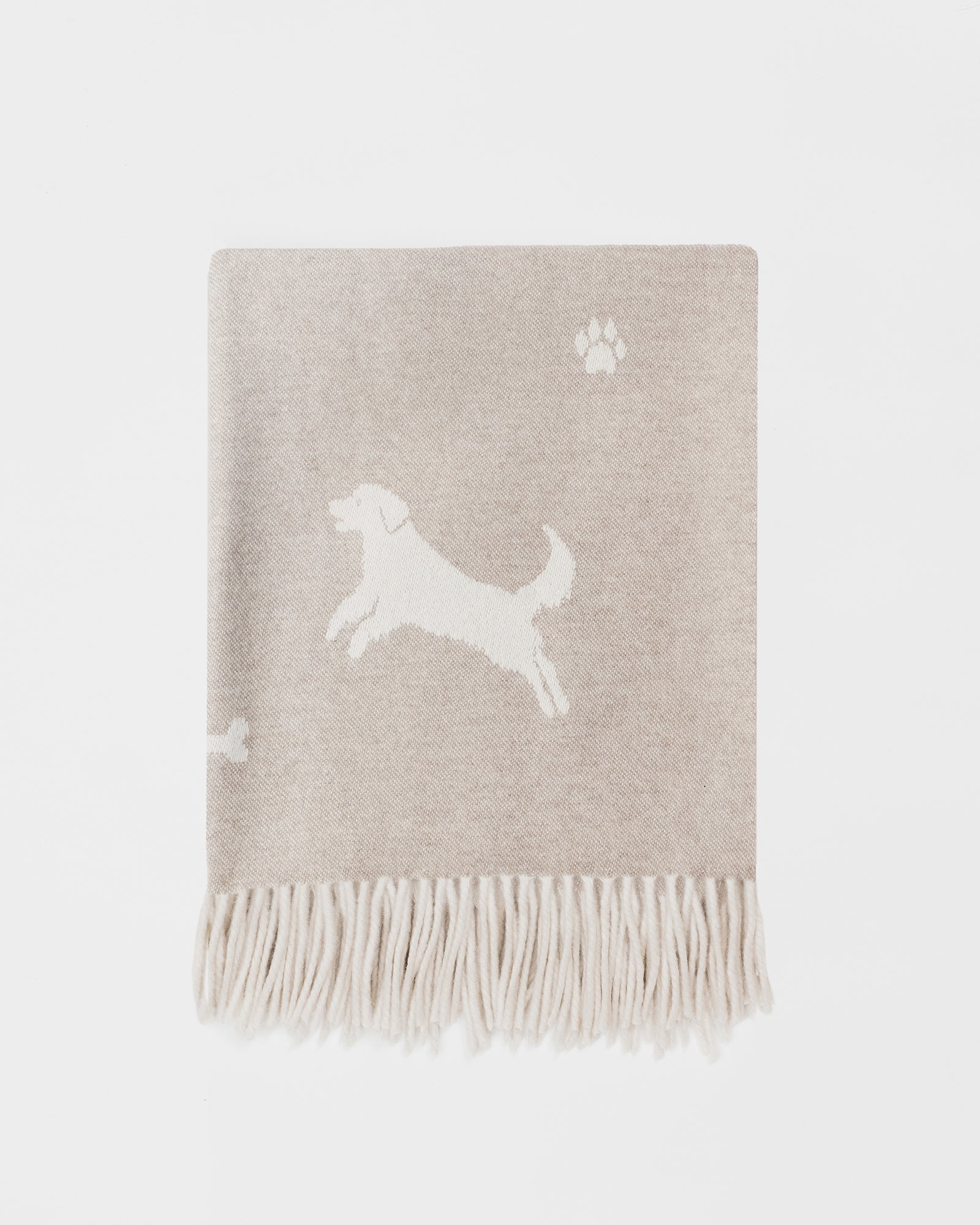 Remony nature multi dog throw - Beige blanket with white dog design and paw prints on a light gray background
