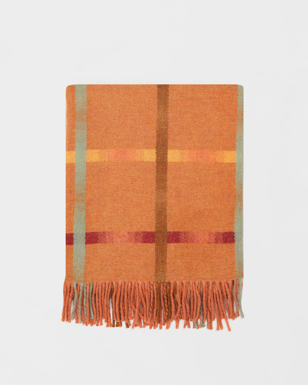 Remony maree spice throw with orange, red, and green colors on a light gray background