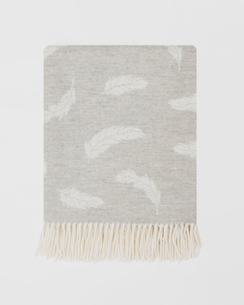 Remony Nature Feather silver grey blanket with white cloud pattern and fringed edge on a light grey background