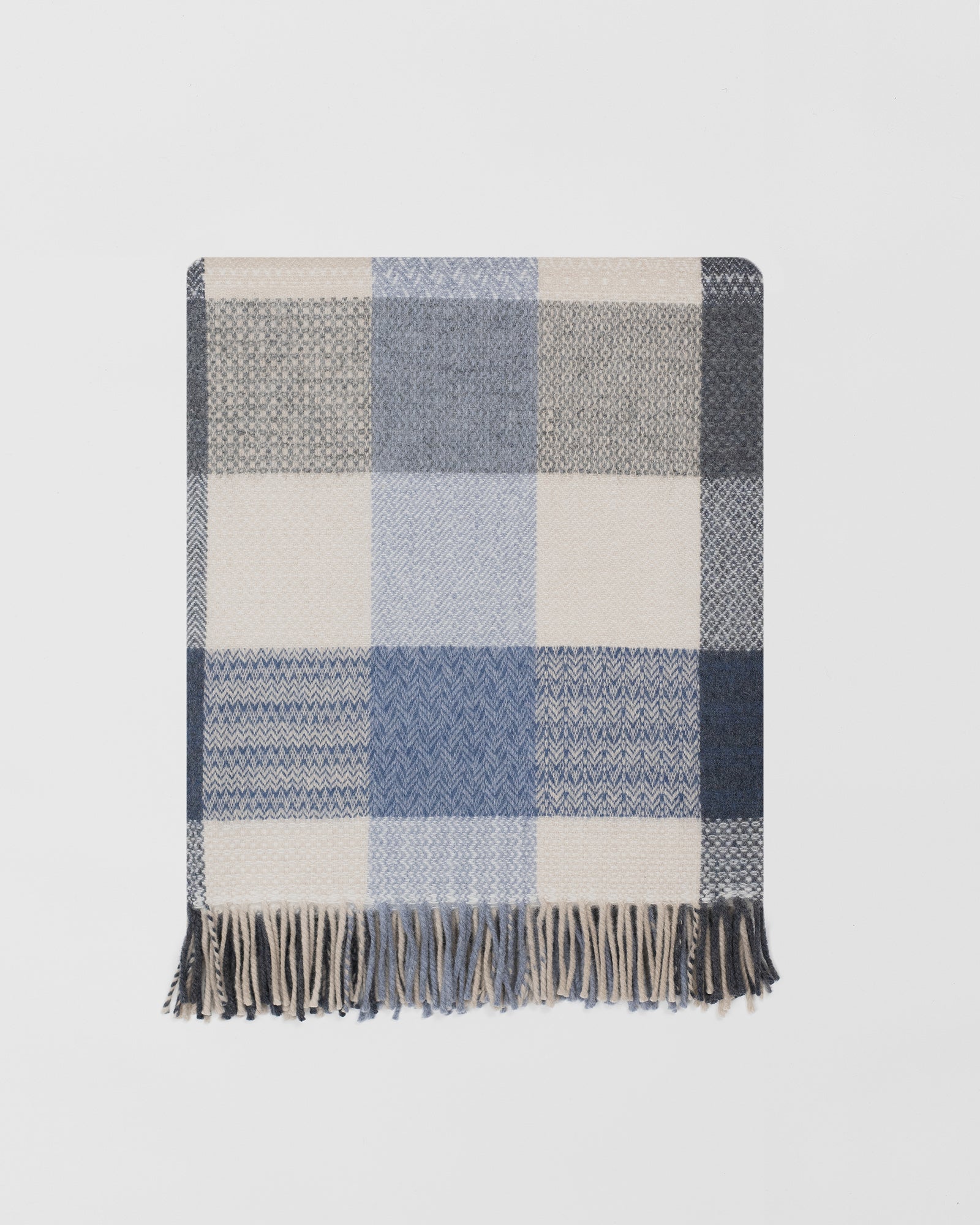 Remony coastline throw - blanket with blue, gray, and beige colors on a light gray background