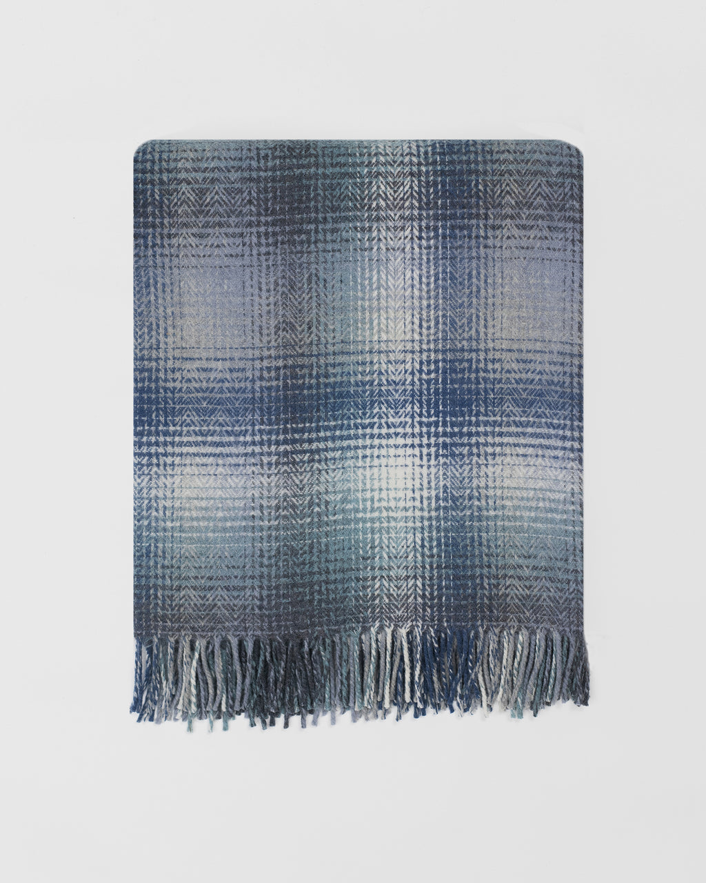 Remony lunan tidal throw in Blue plaid blanket with fringes on a light grey background