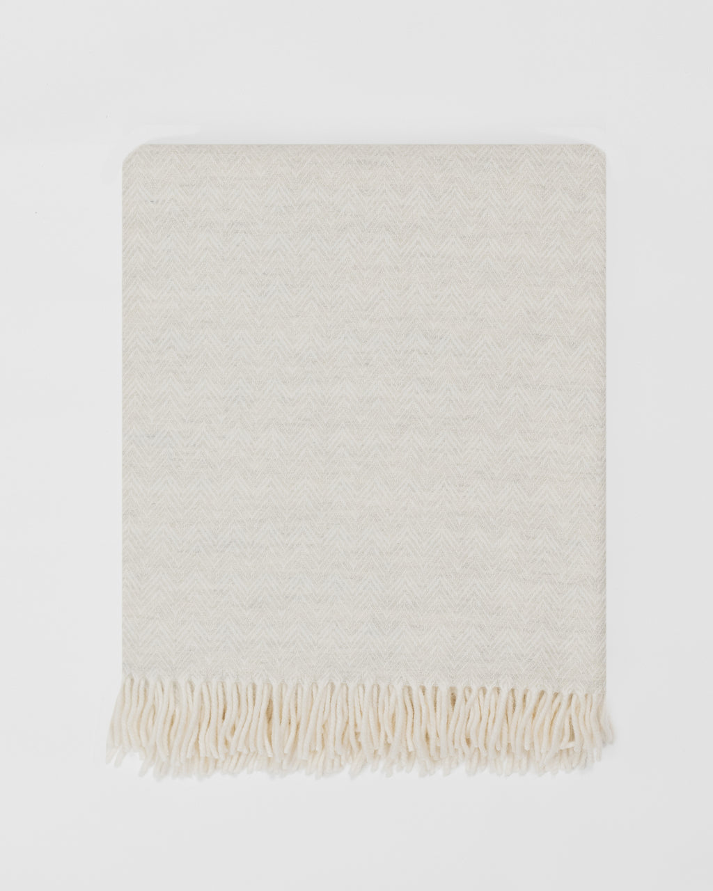 Remony lunan pebble throw - Beige woven blanket with fringes on a white background