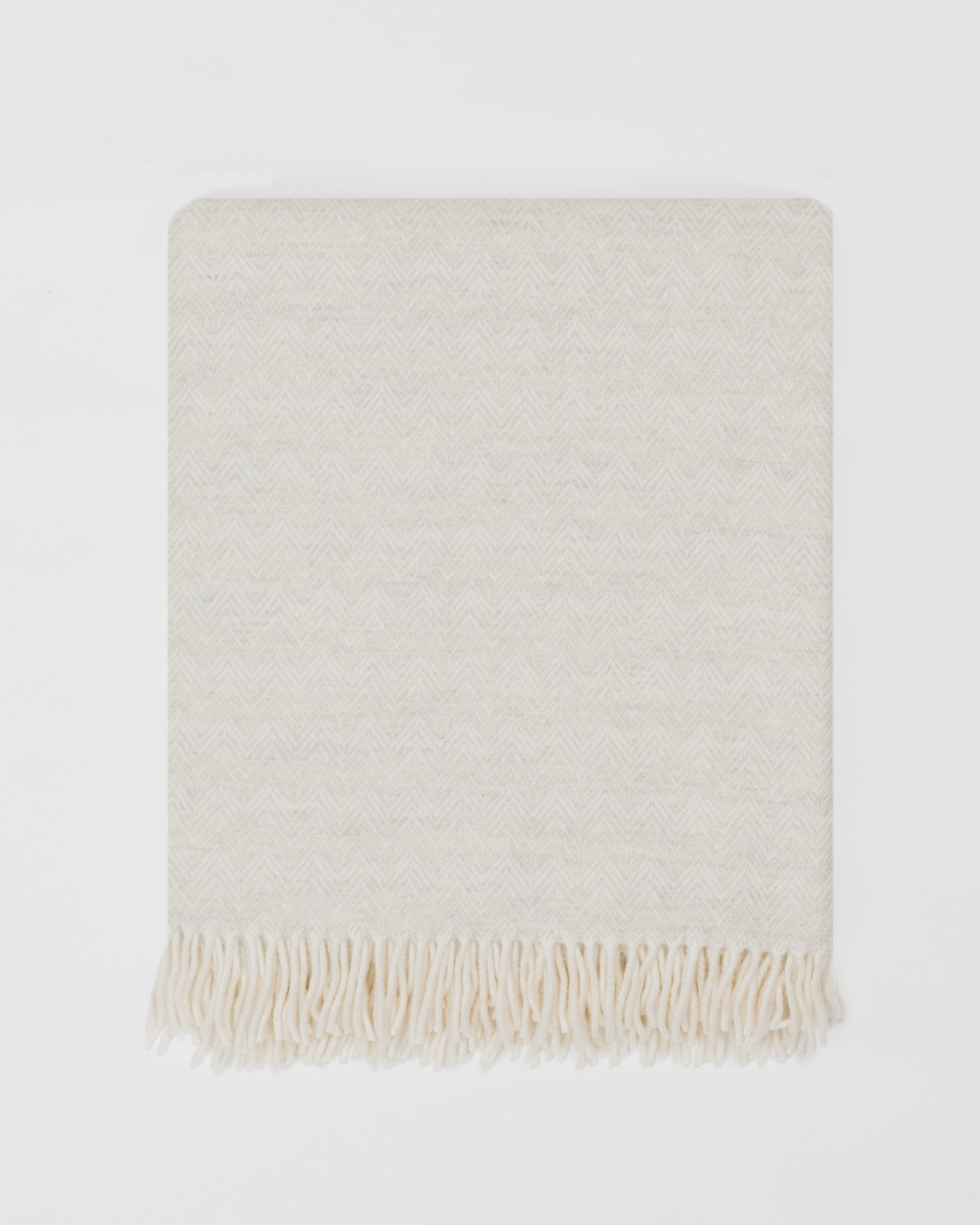 Remony lunan pebble throw - Beige woven blanket with fringes on a white background