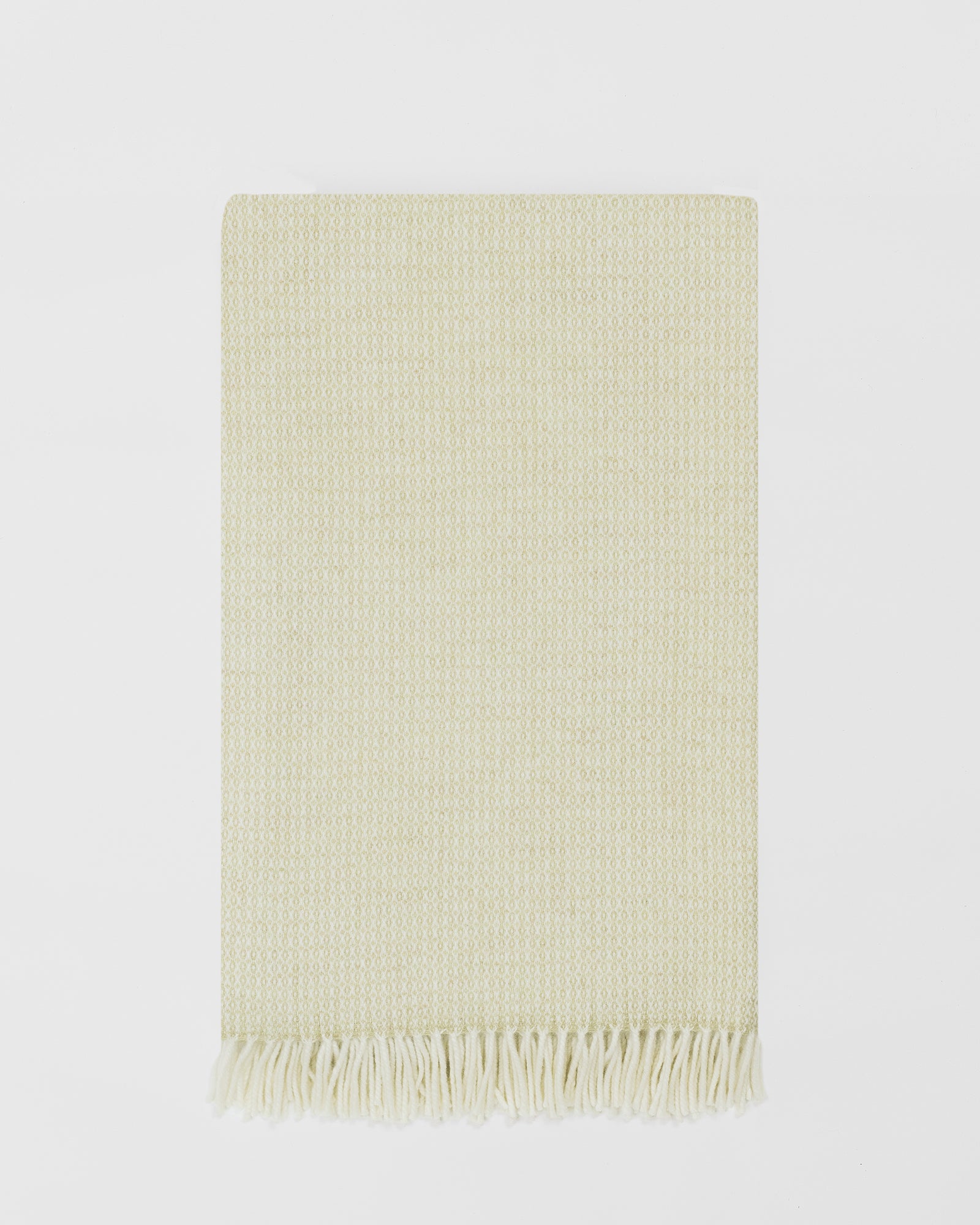 Remony clova moss large throw - woven blanket with fringes on a light gray background