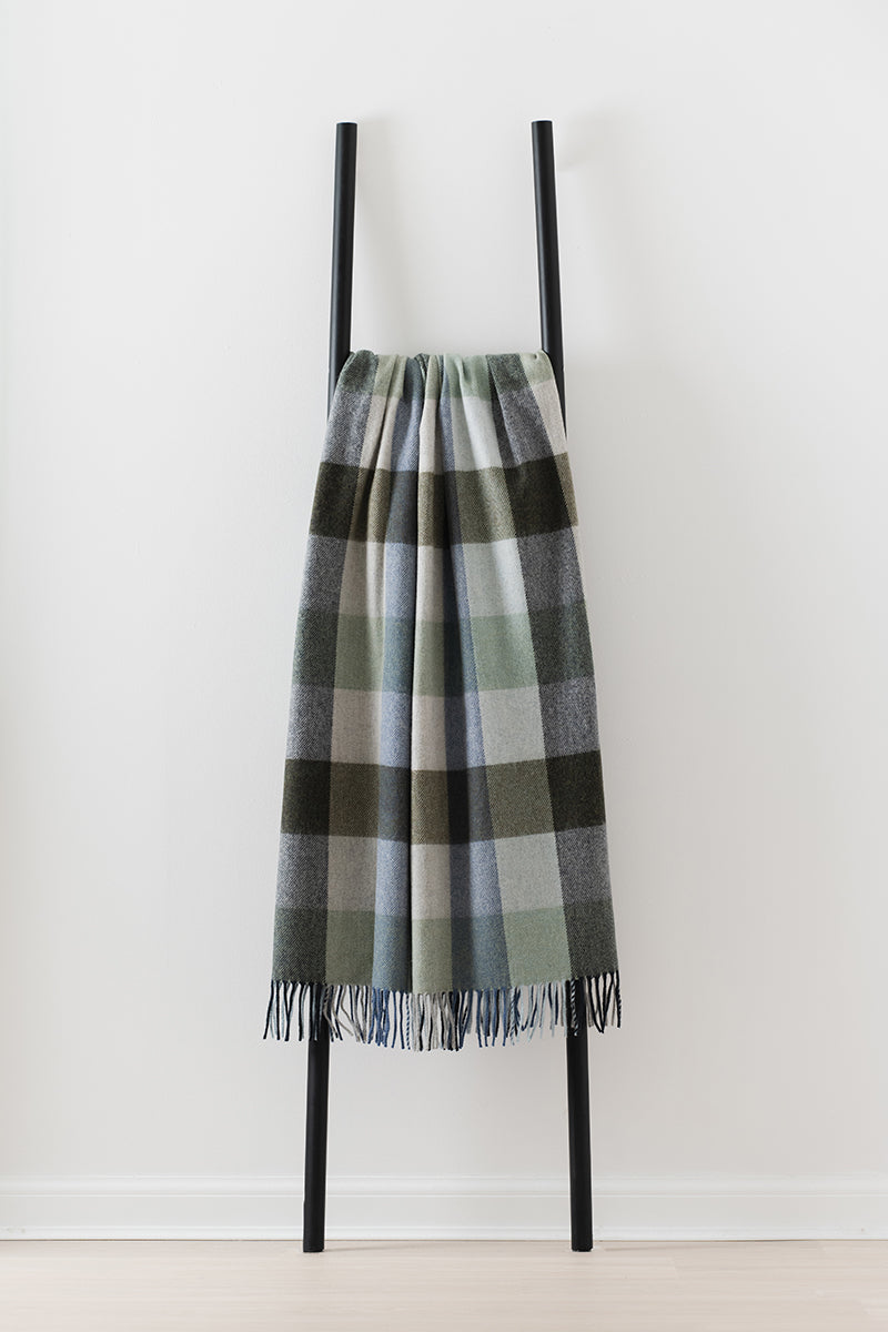 Remony dunira topaz throw - Plaid scarf on a black stand against a white background