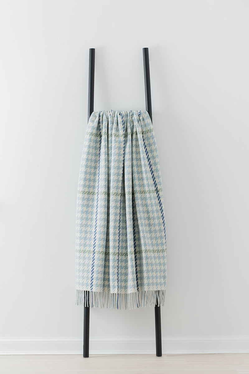 Remony carroglen opal throw - Plaid blanket with fringe on a black ladder against a white background