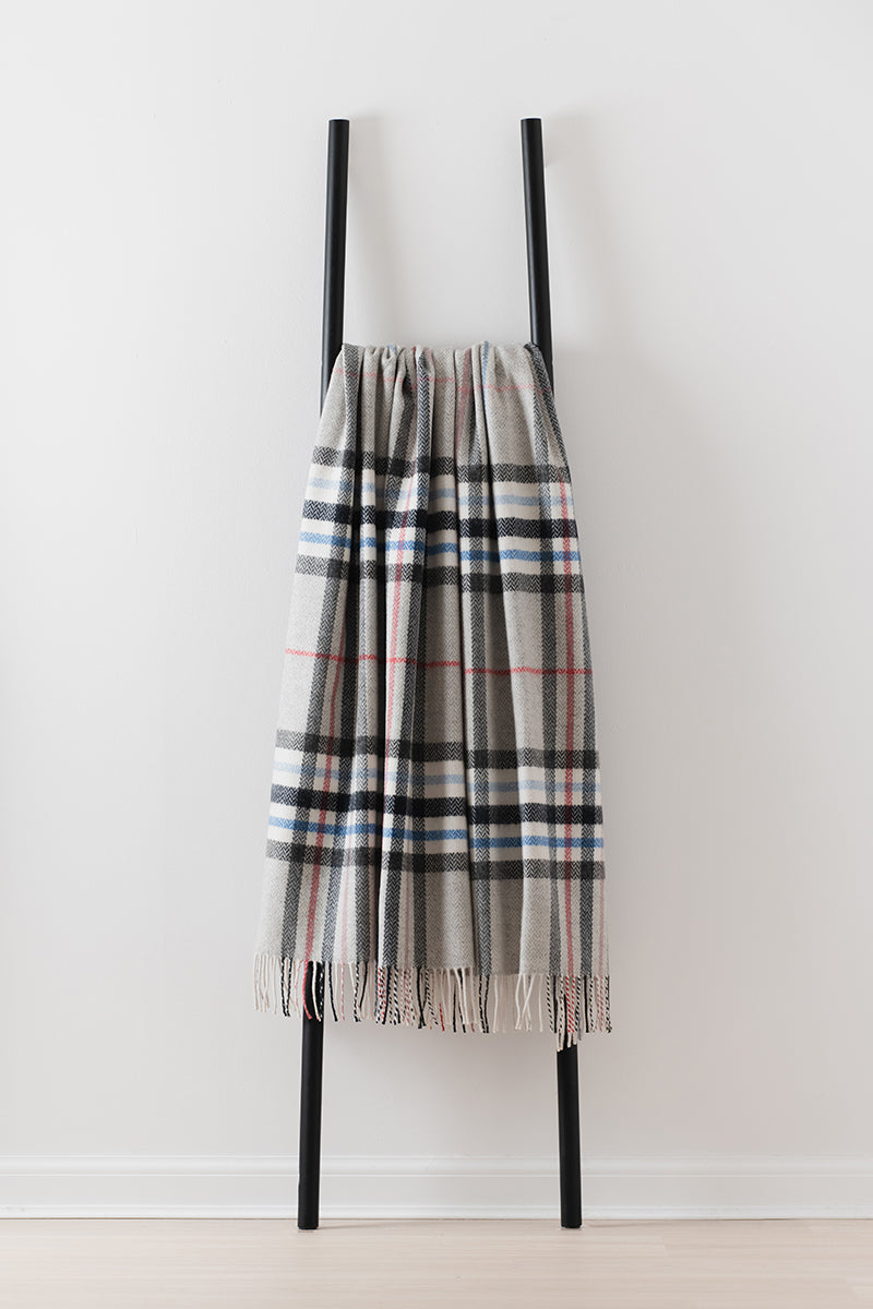Remony moraig pewter throw - Plaid scarf on a black ladder against a white background