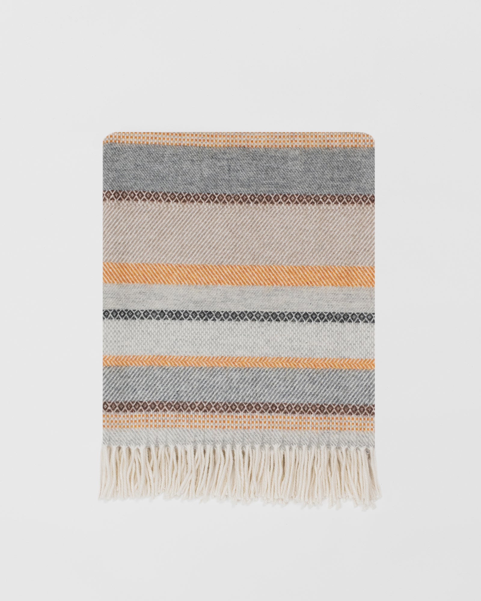 Remony croftmore amber throw - Striped blanket with fringes on a light gray background