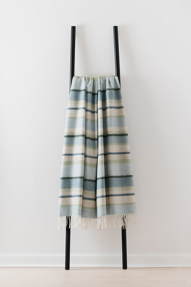 Remony croftmore seaglass - fair isle style blanket draped over a black metal ladder on a white background