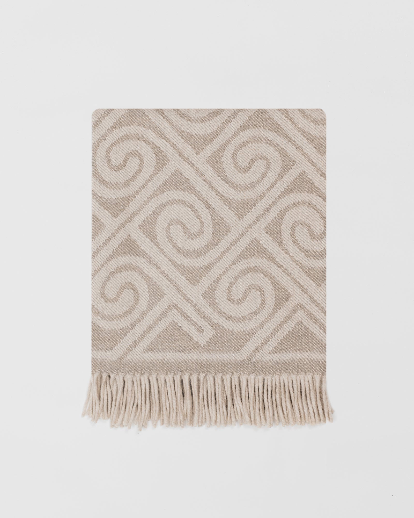 Remony fortriu stone throw - Beige and white patterned throw blanket with fringes on a light gray background