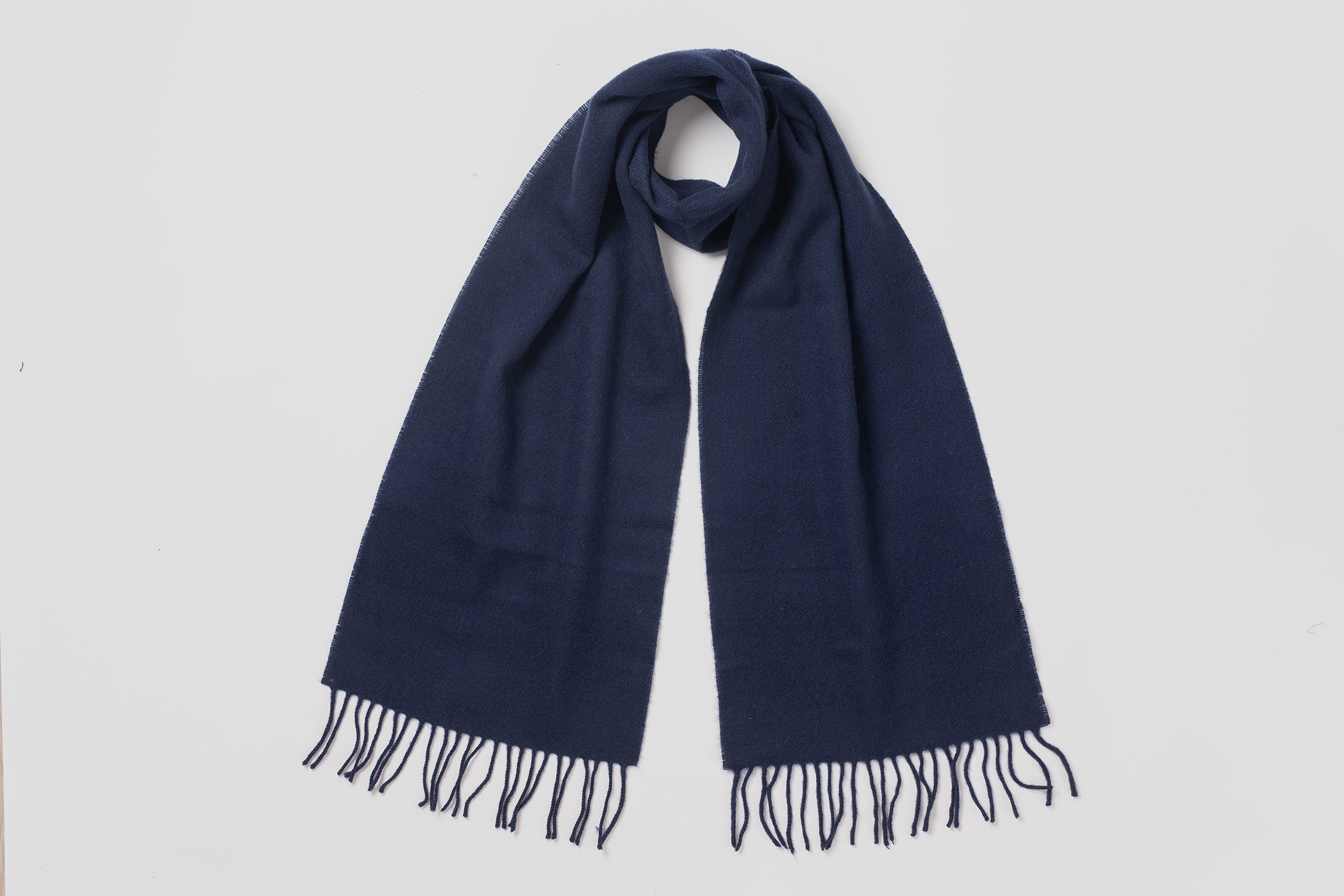 MacN Navy plain scarf - Navy blue scarf with fringes on a light gray background