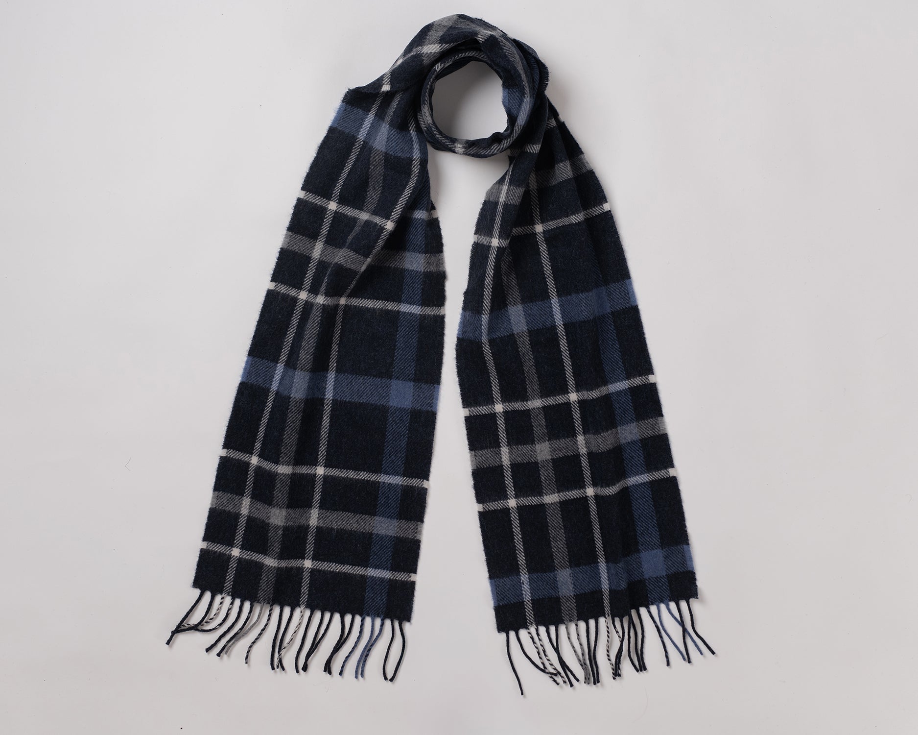 MacN Inchfad navy scarf - Plaid scarf with fringes on a light gray background